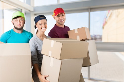 Packed moving boxes and furniture prepared for urgent collection