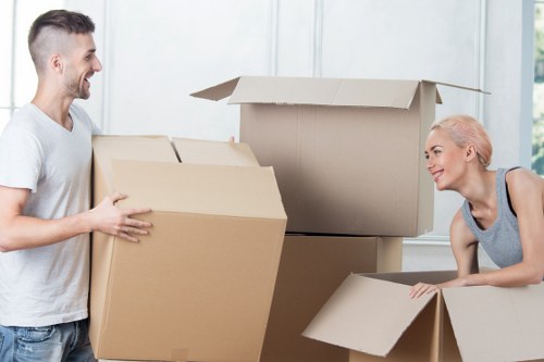 Professional movers loading household furniture for a local North London removal