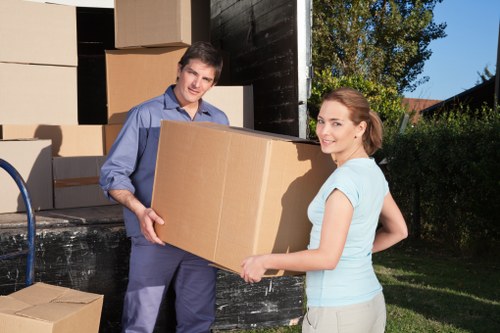 Removal team handling household items in a North London flat move